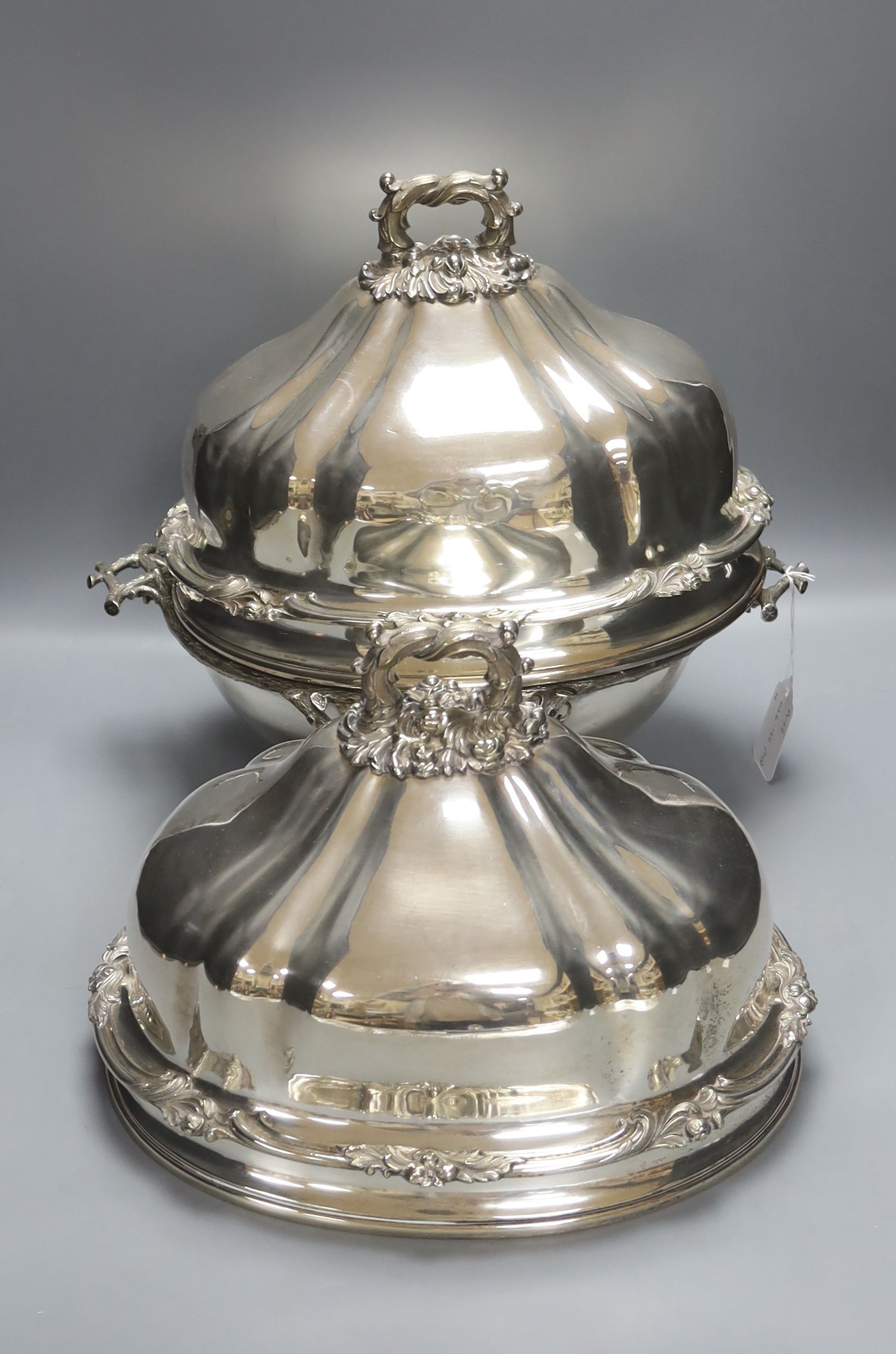 A pair of Victorian silver plated meat covers, 30cm and a similar roll-top breakfast dish (3)